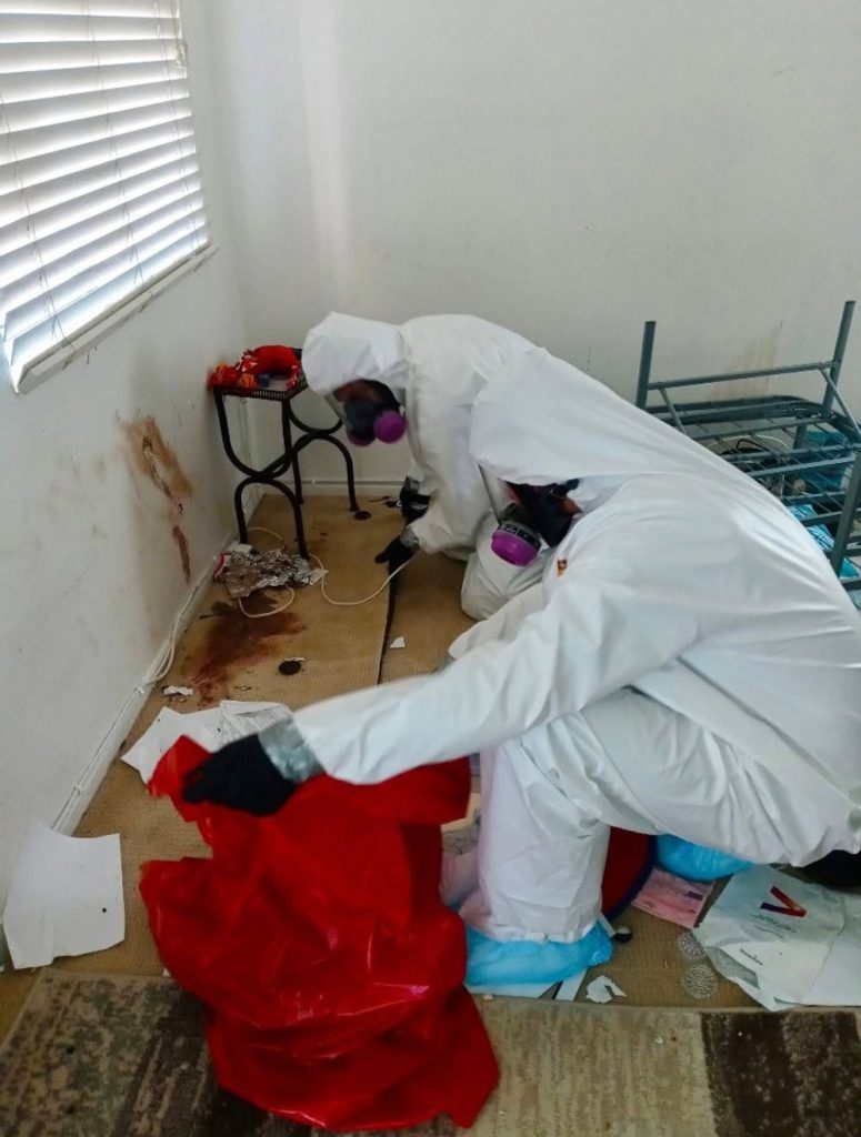 Biosafe Recovery technician in protective suit during biohazard cleanup in Colorado
